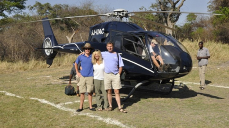 Zambia and Malawi combined - left to right Charlie, Tracy and Francis by a helicopter
