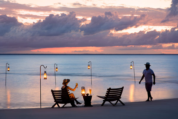 Couples romantic sundowner on the beach Benguerra Island, Mozambique and Beyond