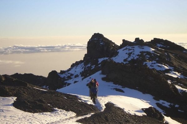 climbers walking through snow near summit of Kilimanjaro